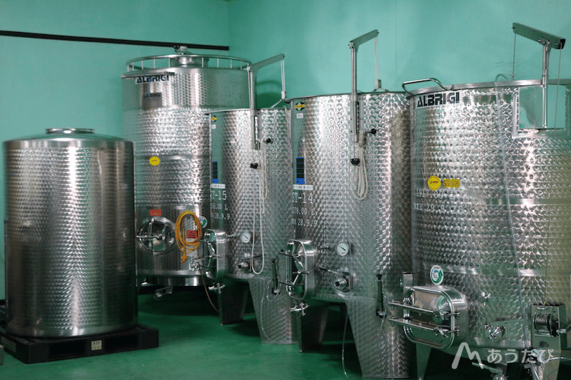 Large fermentation tanks inside a Japanese winery