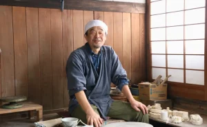 Kaneda smiling inside his pottery workshop