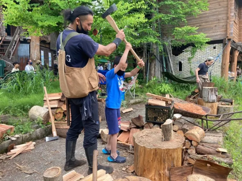 Japanese lumberjack splitting firewood with a child in rural Japan