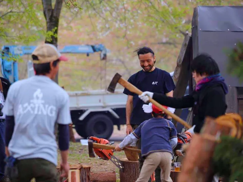 Children participating in a firewood chopping workshop in Japan