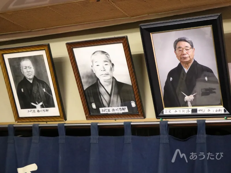 Historical photos of past generations displayed on a wall