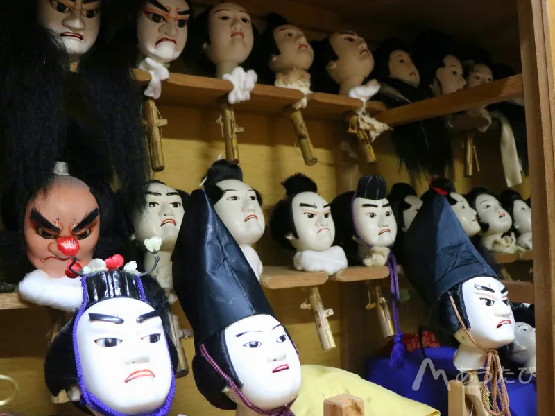 Puppet heads lined up in a workshop
