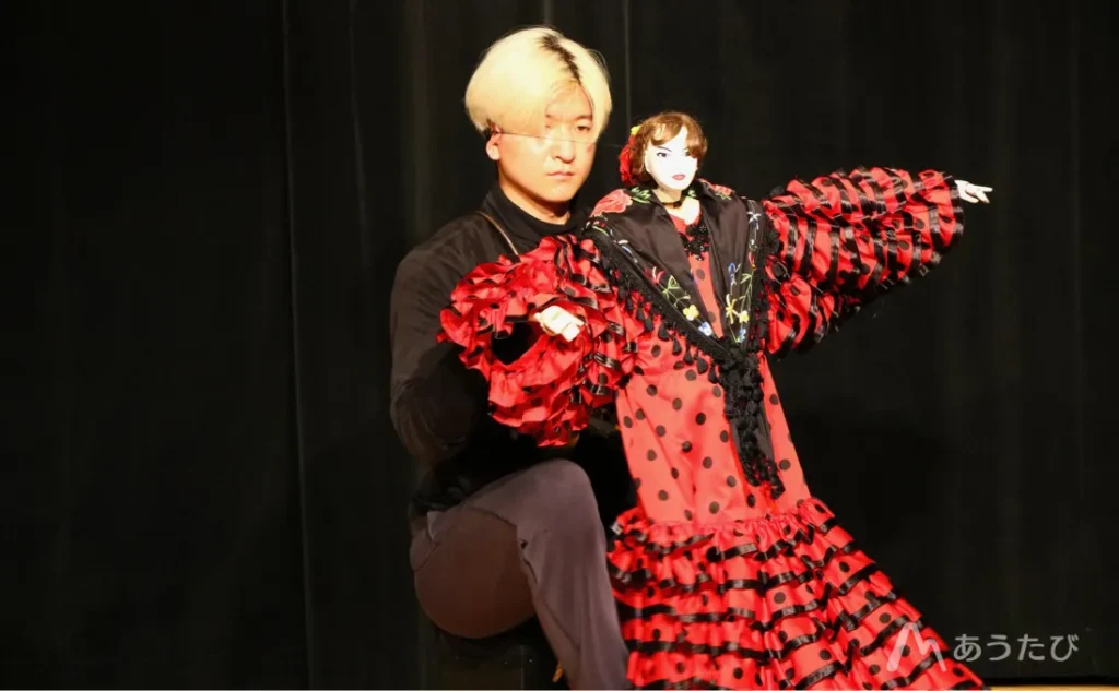 Ryuji performing with a traditional puppet