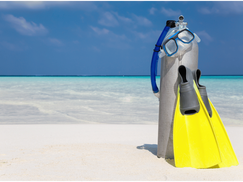 Diving equipment placed on a sandy beach
