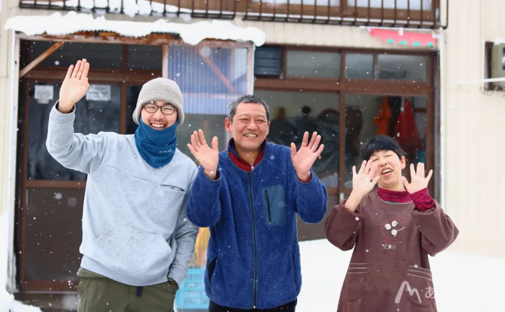 The Yokoyama family smiling and waving