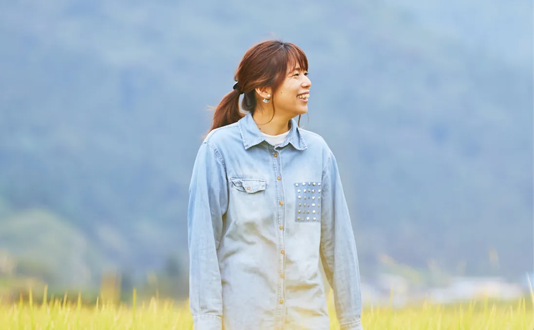 Ryoko smiling in a rice field in rural Japan