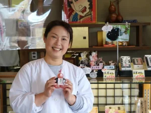 Fumie Watanabe of Tamaya Gyokushindo smiling in her wagashi shop in Nihonmatsu