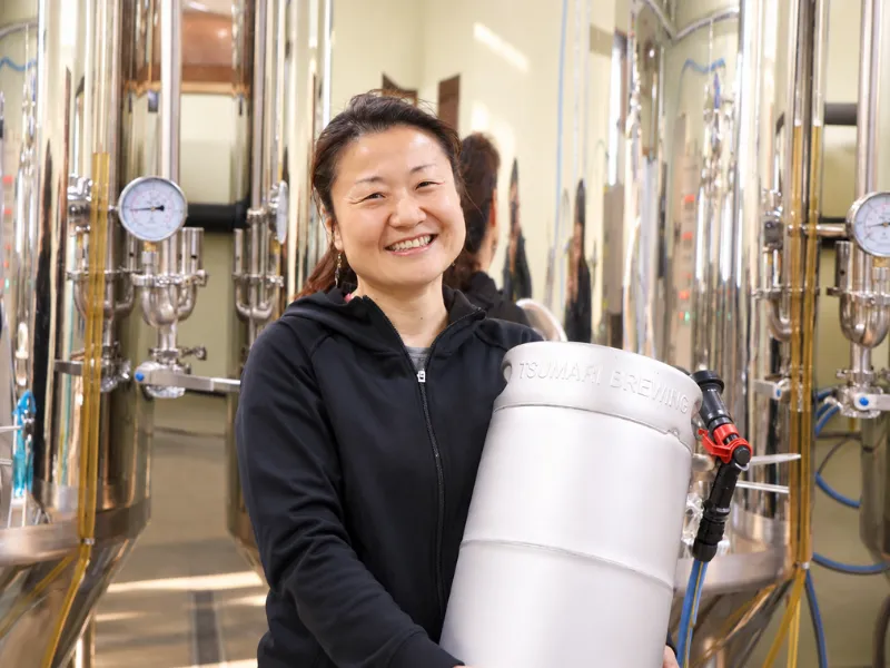 Chiho Takagi holding a beer keg inside the Tsumari Beer brewery in Tokamachi